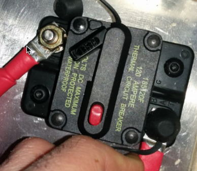 Applying a twisting force to the first cable on the breaker.