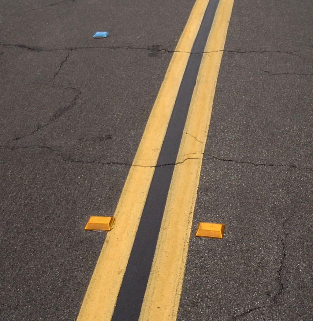 Center line divider retroreflective markers on the road.